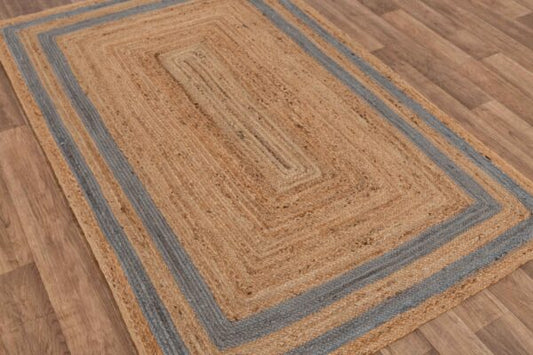 Braided jute area rug with blue stripes, rectangular shape, earthy tones, perfect for cozy home decor.