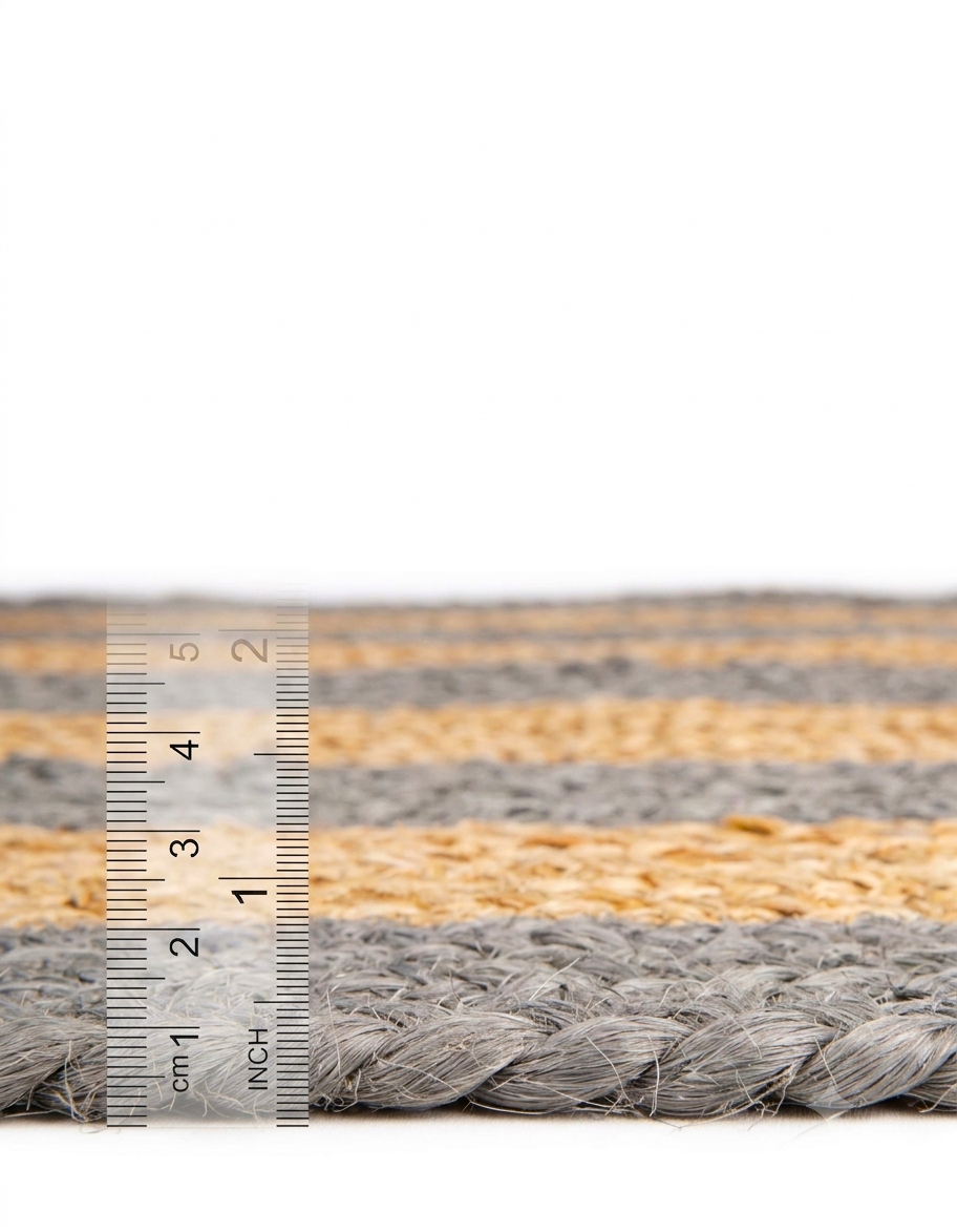 Natural Jute Area Rug with braided border, close up showing grey and tan fibers and a ruler for size measurement