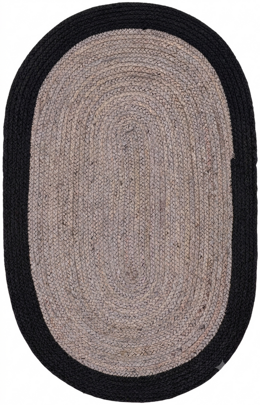 Oval braided rug with black border on a white background