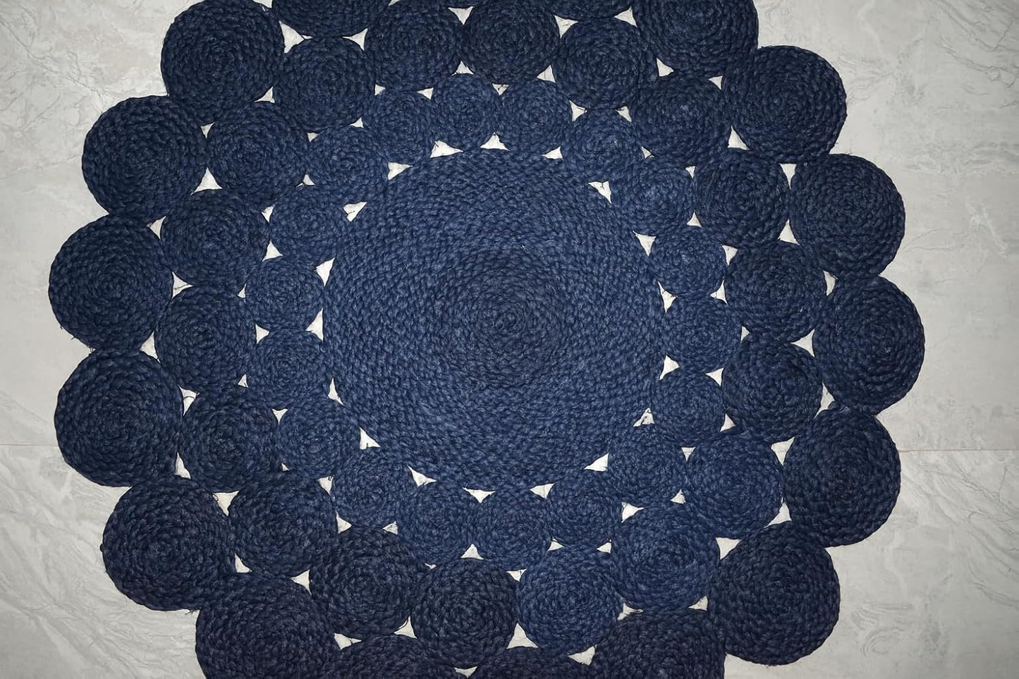 Natural Jute Area Rug in a circular design with textured woven patterns, perfect for enhancing any room's decor.