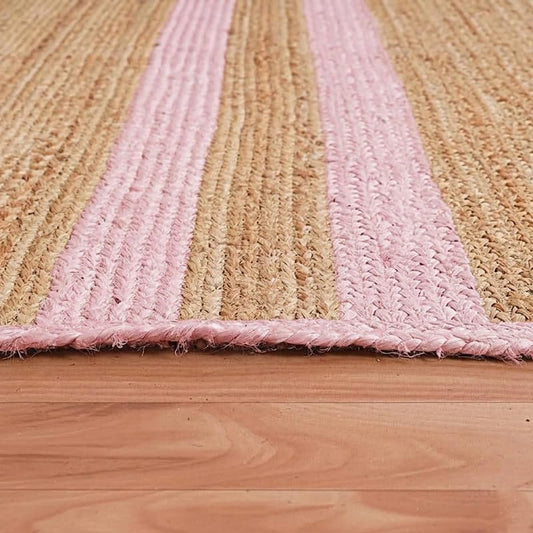 Natural jute Bed Side Runner with pink striped bands, fringed edges on a wooden floor