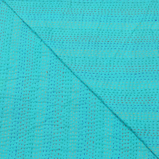 Close-up of turquoise fabric with a subtle pattern