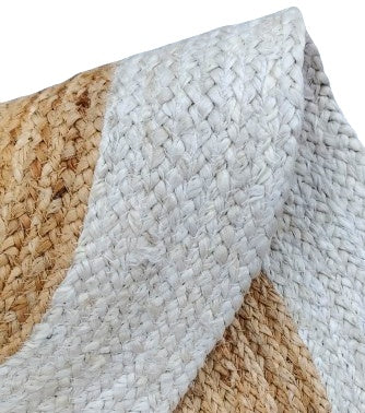Close-up of a woven rug with natural and white patterns
