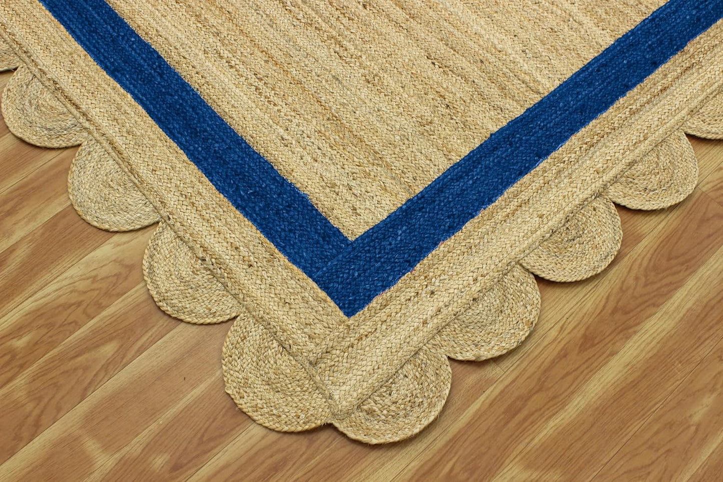 Natural Jute Area Rug with scalloped edges and navy blue trim, perfect for adding texture to any living space.