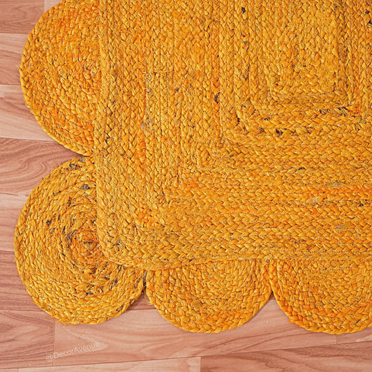 Yellow braided rug on a wooden floor