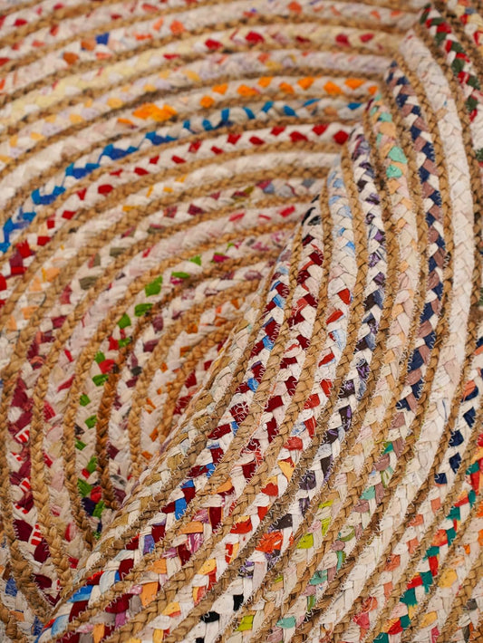 Colorful braided jute rug with vibrant patterns, perfect for home decor and adding texture to any space.