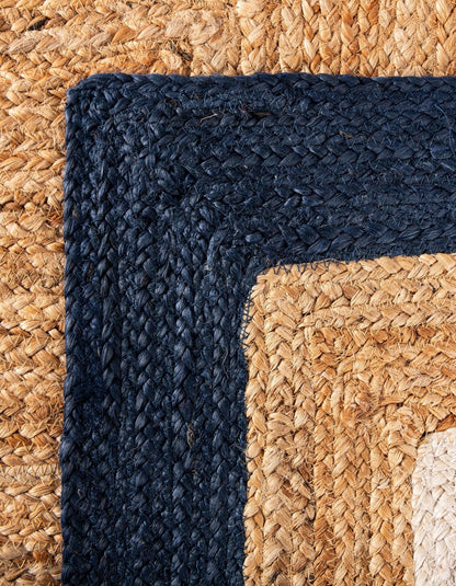 Navy blue and natural woven jute rug corner, featuring durable, eco-friendly material and stylish texture.