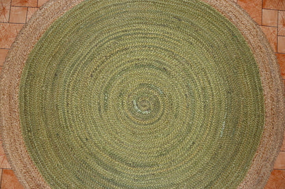 Round green braided rug on a tiled floor