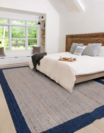 Natural Jute Area Rug in beige and navy, hand-braided runner style for indoor bedroom flooring with a solid border pattern