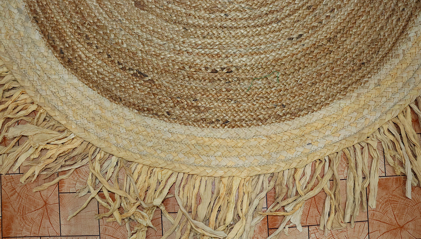 Round woven rug with fringes on a tiled floor