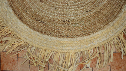 Round woven rug with fringes on a tiled floor