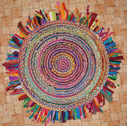 Colorful braided rug with tassels on a wooden floor