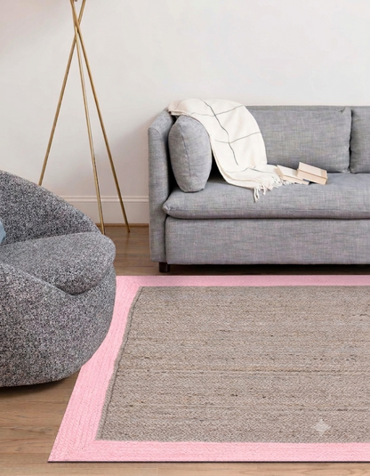 Natural Jute Area Rug in beige and pink with braided texture, hand-braided natural jute area rug for indoor floor use