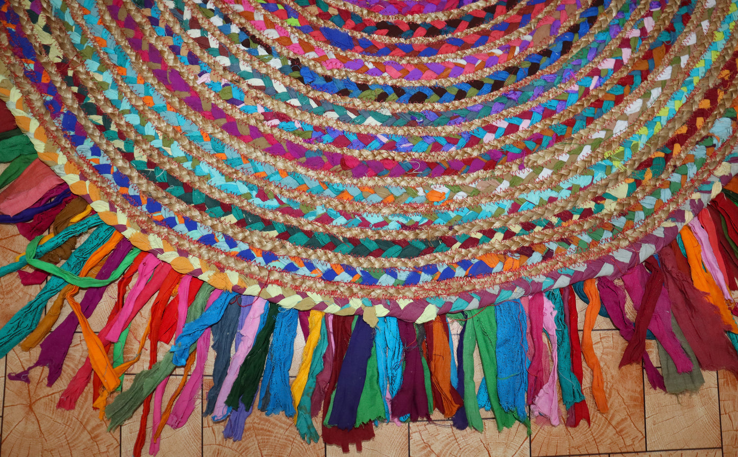 Vibrant Natural Jute Area Rug with colorful braided accents and fringed edges, perfect for adding texture to any space.