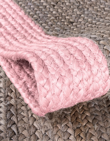 Natural Jute Area Rug in light pink with braided texture, floor carpet runner style on a gray woven background