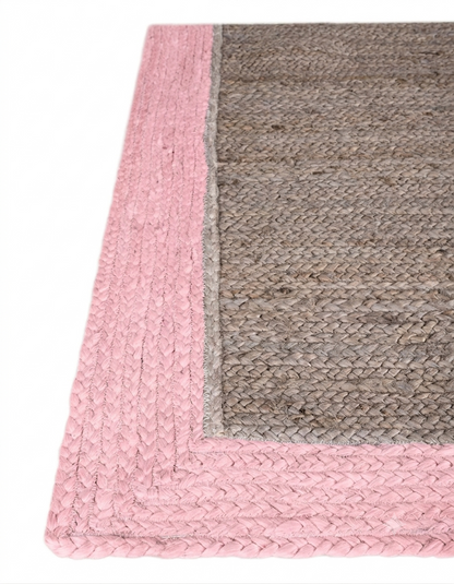 Natural Jute Area Rug with pink and gray braided border, hand-braided construction and textured weave corner detail