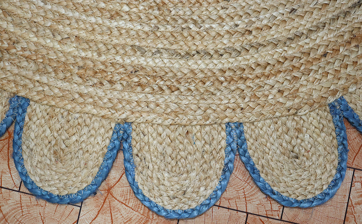 Textured woven mat with blue decorative elements on a wooden surface