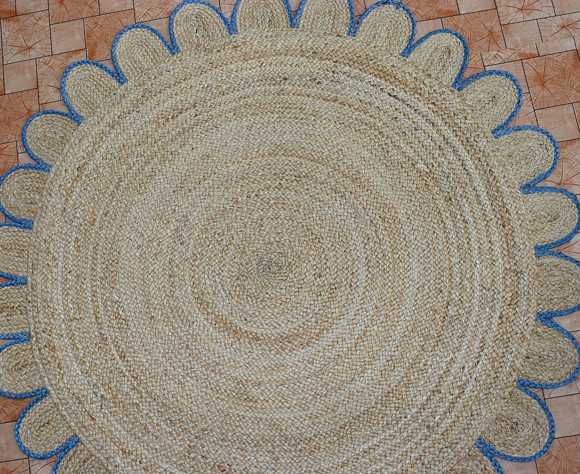Round woven mat with blue border on a checkered floor