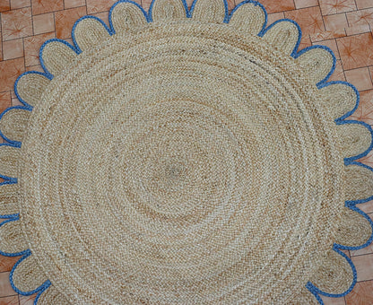 Round woven mat with blue border on a checkered floor