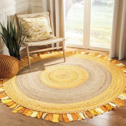 Round braided rug with multicolor pattern on wooden floor, chair with pillow in background