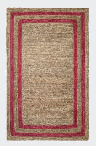 Natural jute area rug with vibrant pink borders, eco-friendly material, perfect for modern decor.