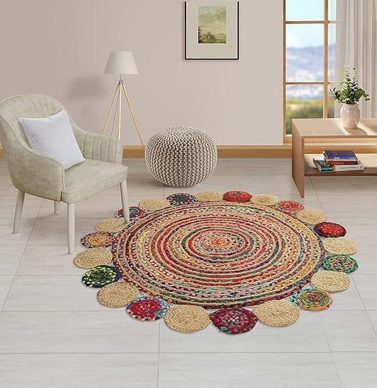 Round multicolored braided rug in a room with a chair, ottoman, and window.
