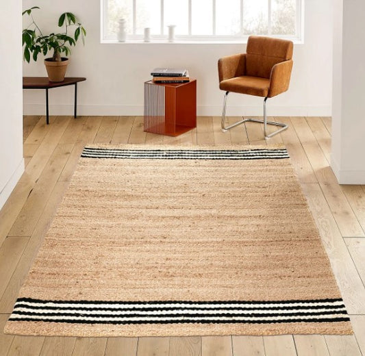 Natural jute area rug with black and white stripes, perfect for modern home decor.