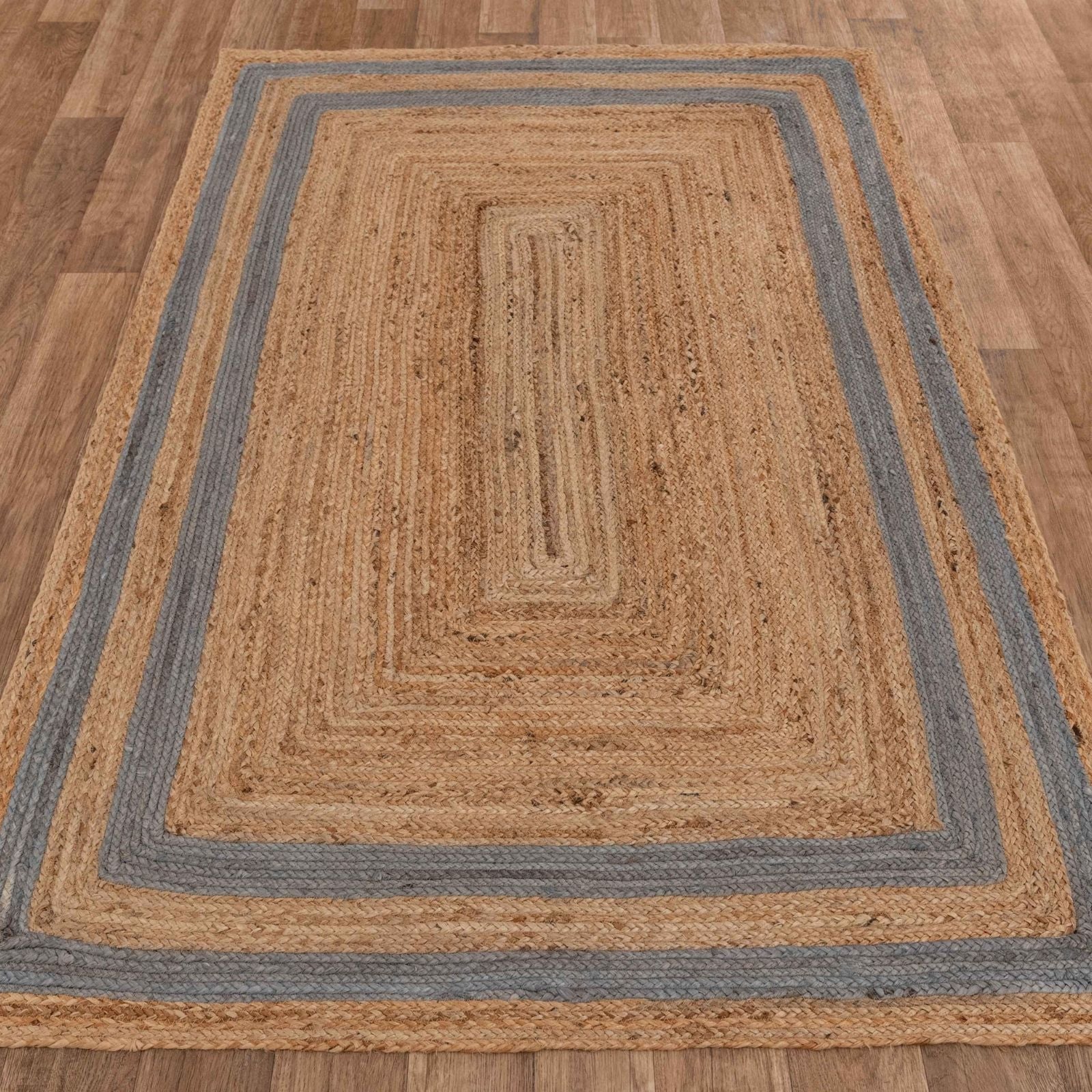 Natural jute area rug with blue stripes, rectangular shape, adding a rustic touch to any space.