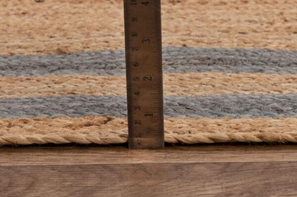 Natural jute rug with gray stripes, featuring a height measurement close-up.