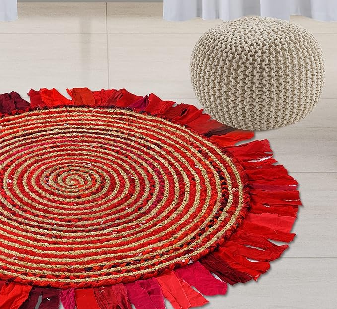 Round red and gold braided rug with fringe on a light wooden floor.