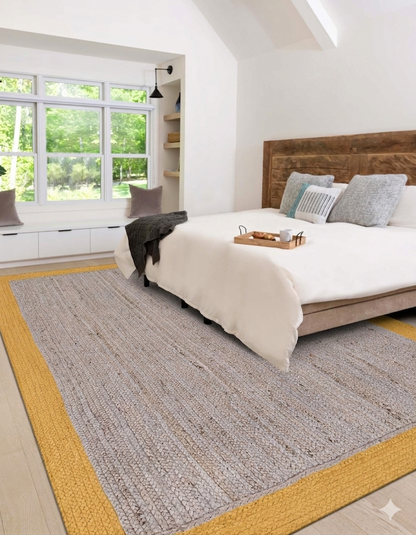 Bedroom with a large bed, wooden headboard, and a textured gray rug with yellow border.