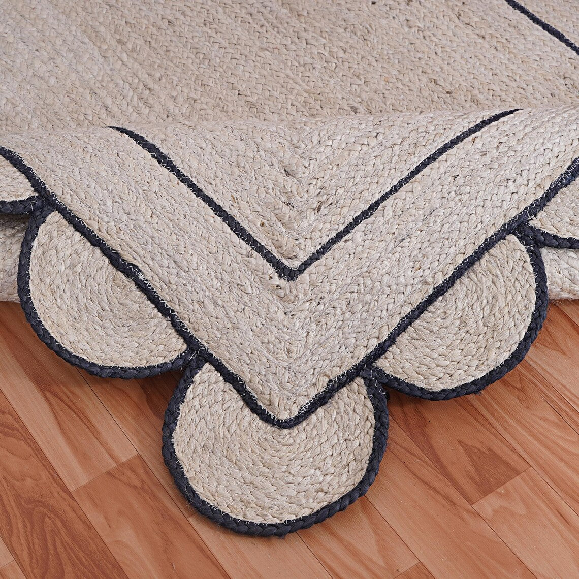 Natural Jute Area Rug with scalloped edges and navy trim — a versatile floor carpet perfect for any room.