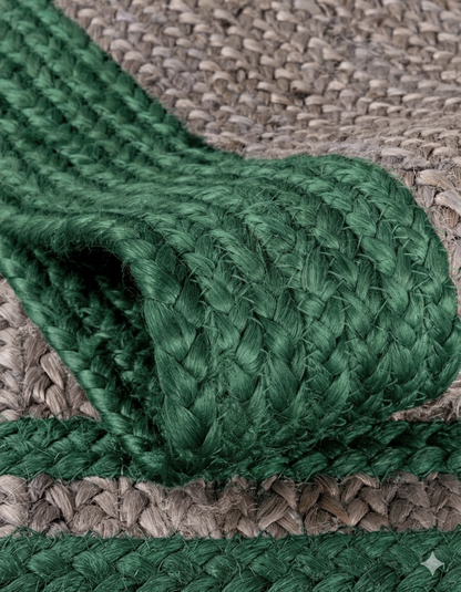Close-up of a green braided rope on a textured brown surface