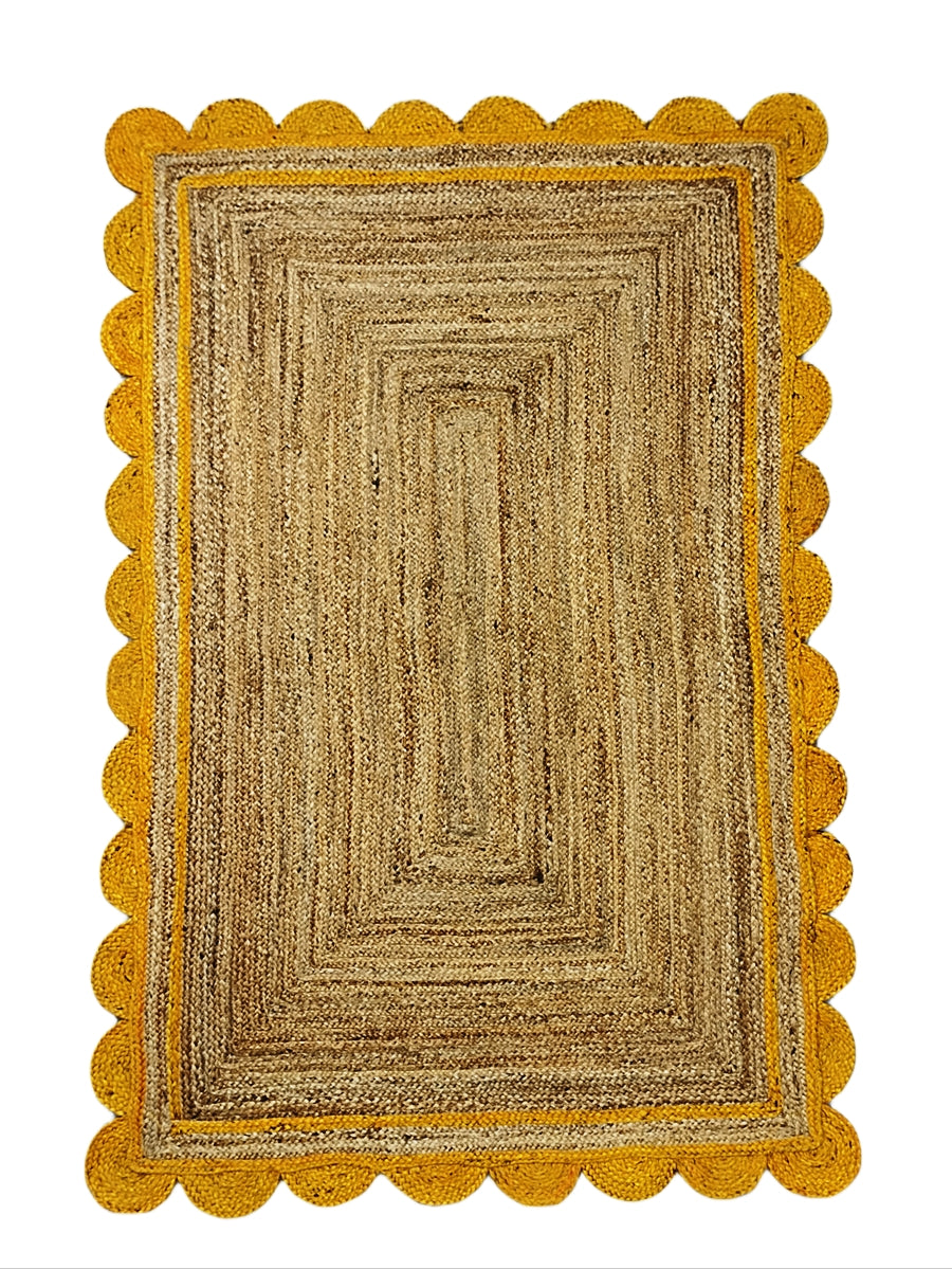 Rectangular jute rug with scalloped yellow border on a white background