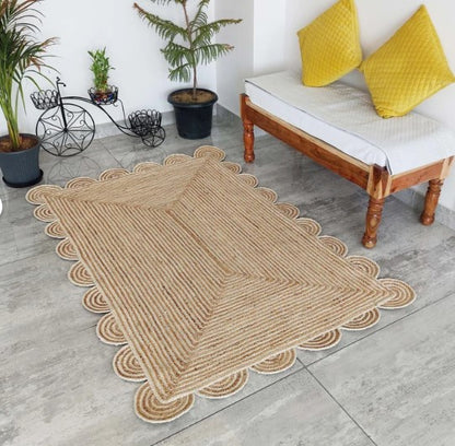 Handwoven beige scalloped area rug, perfect for stylish home decor.