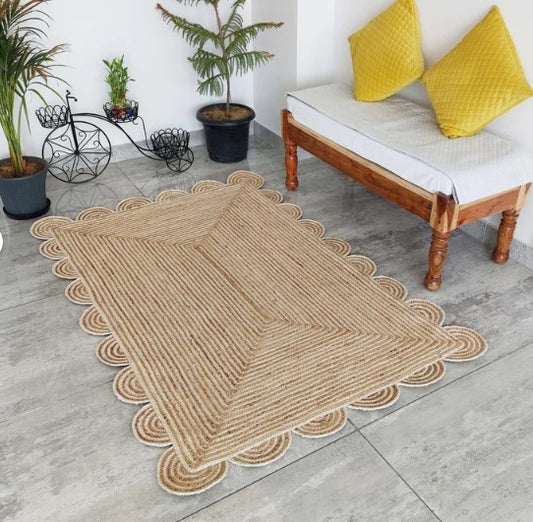Handwoven beige scalloped area rug, perfect for stylish home decor.