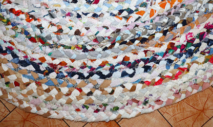 Multicolored braided rug on a wooden floor