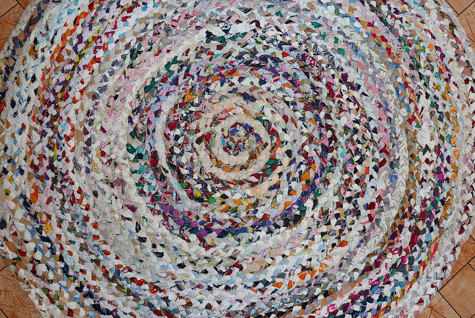 Multicolored braided rug on a wooden floor