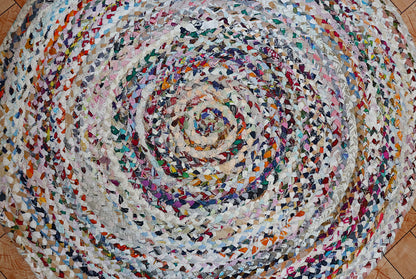 Multicolored braided rug on a wooden floor