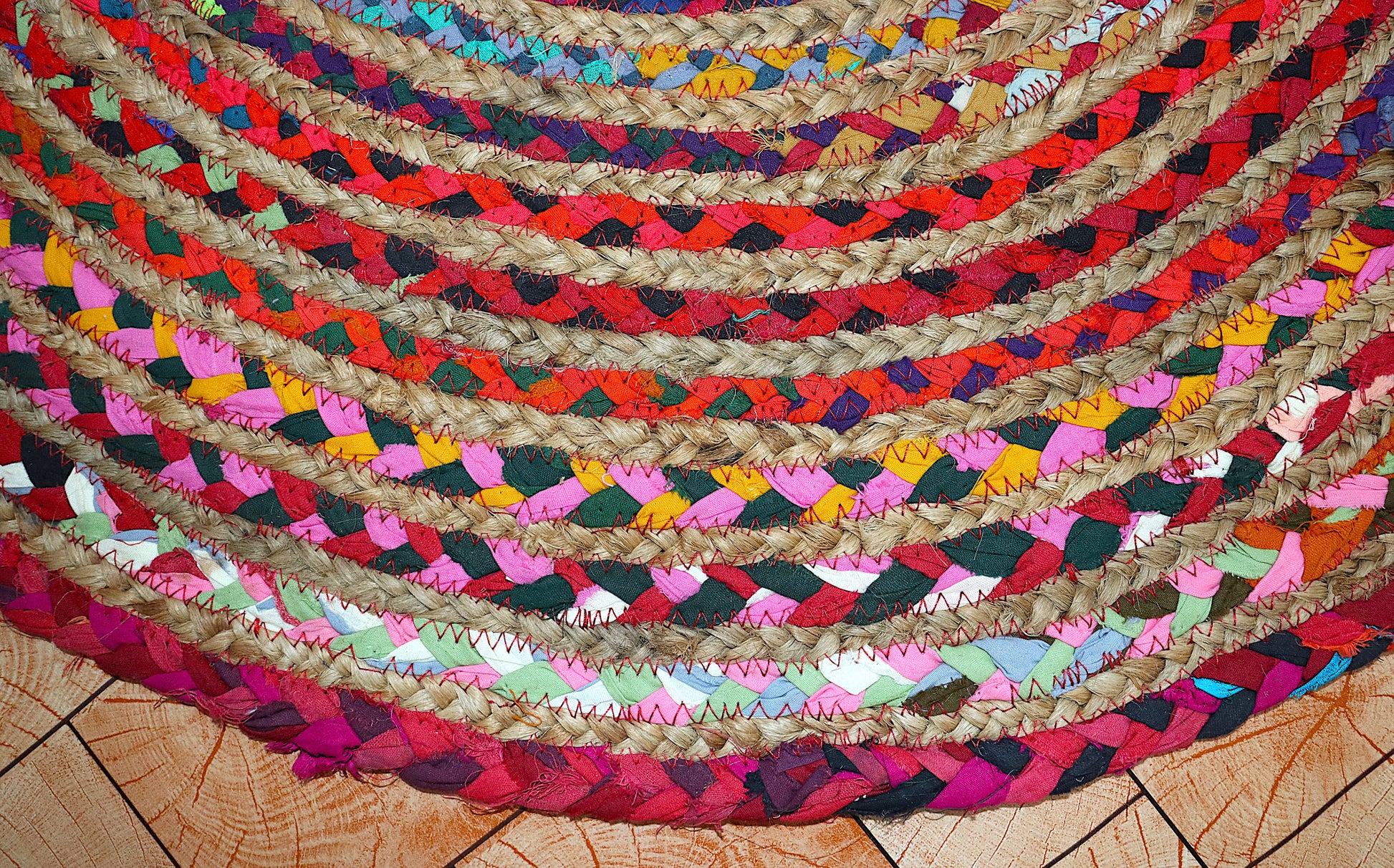 Colorful braided rug on a wooden floor