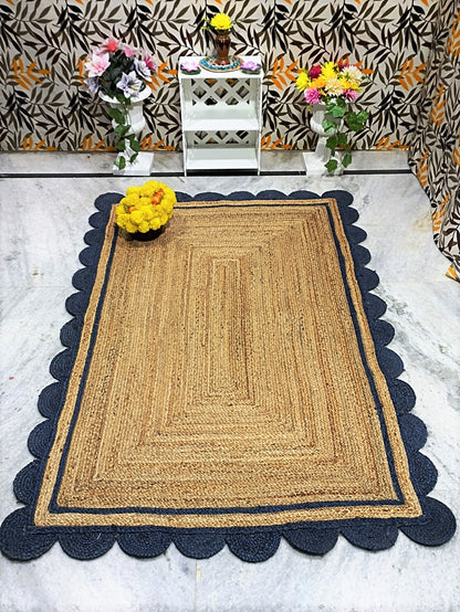 Jute rug with scalloped edge on a marble floor, with decorative flowers and a patterned wall in the background.