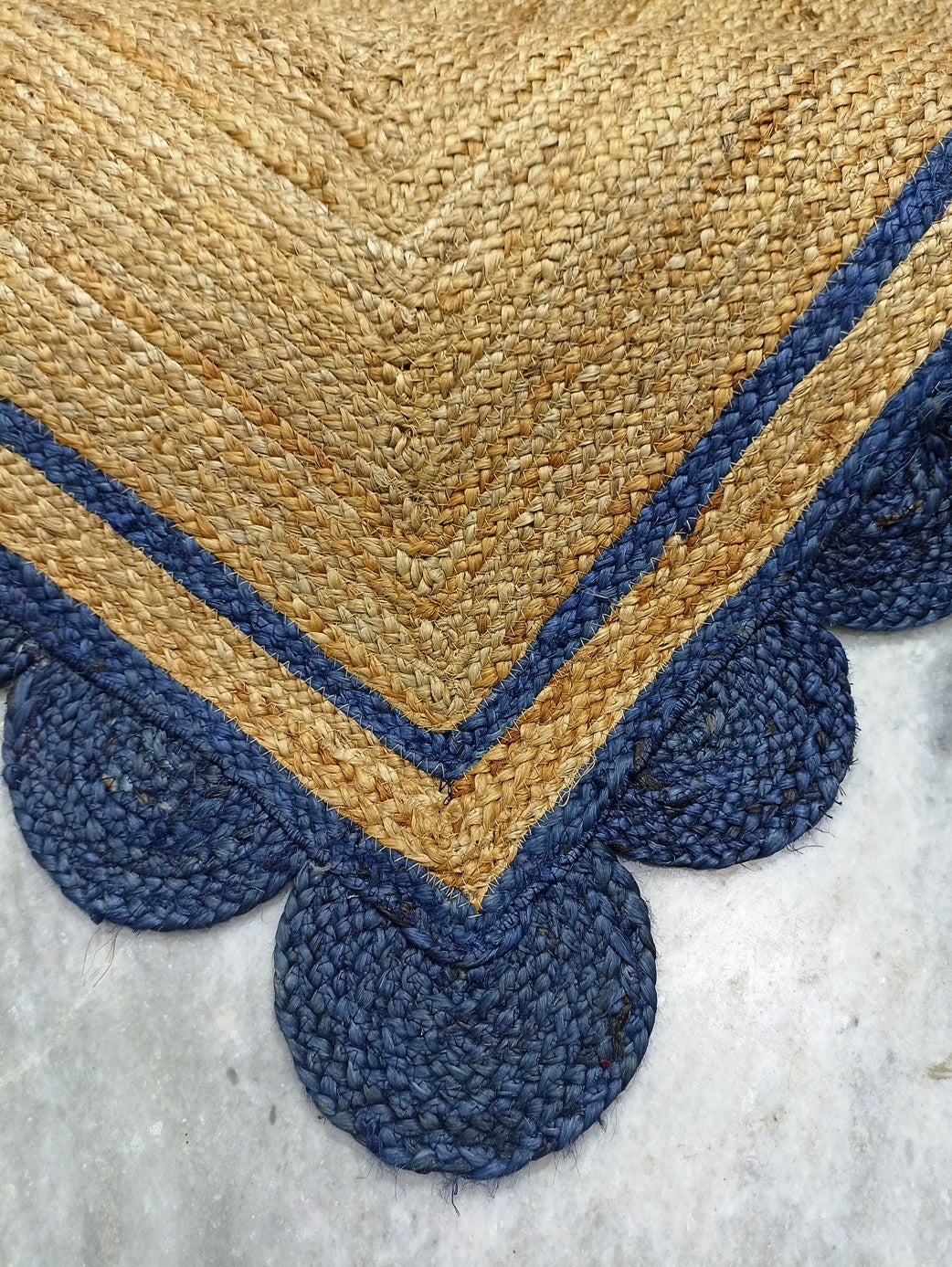 Textured rug with a geometric pattern on a concrete floor