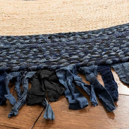 Textured blue rug with tassels on a wooden floor