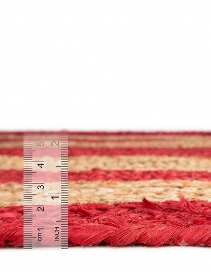 Natural Jute Area Rug floor carpet with red and beige woven stripes, close-up with measuring ruler