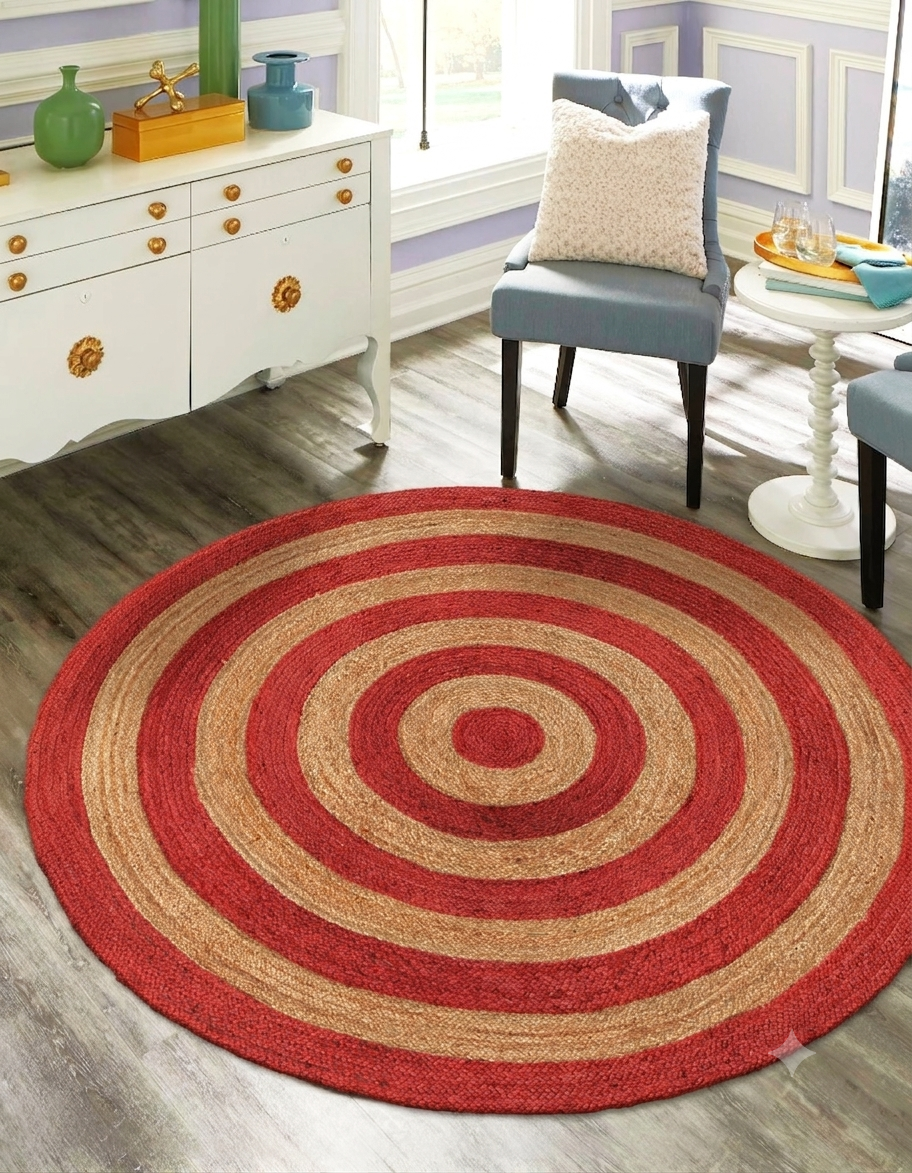 Round red and beige rug in a room with furniture and decor.