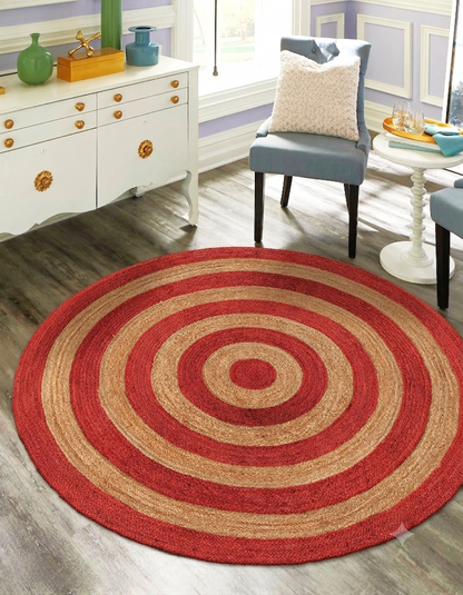 Round red and beige rug in a room with furniture and decor.