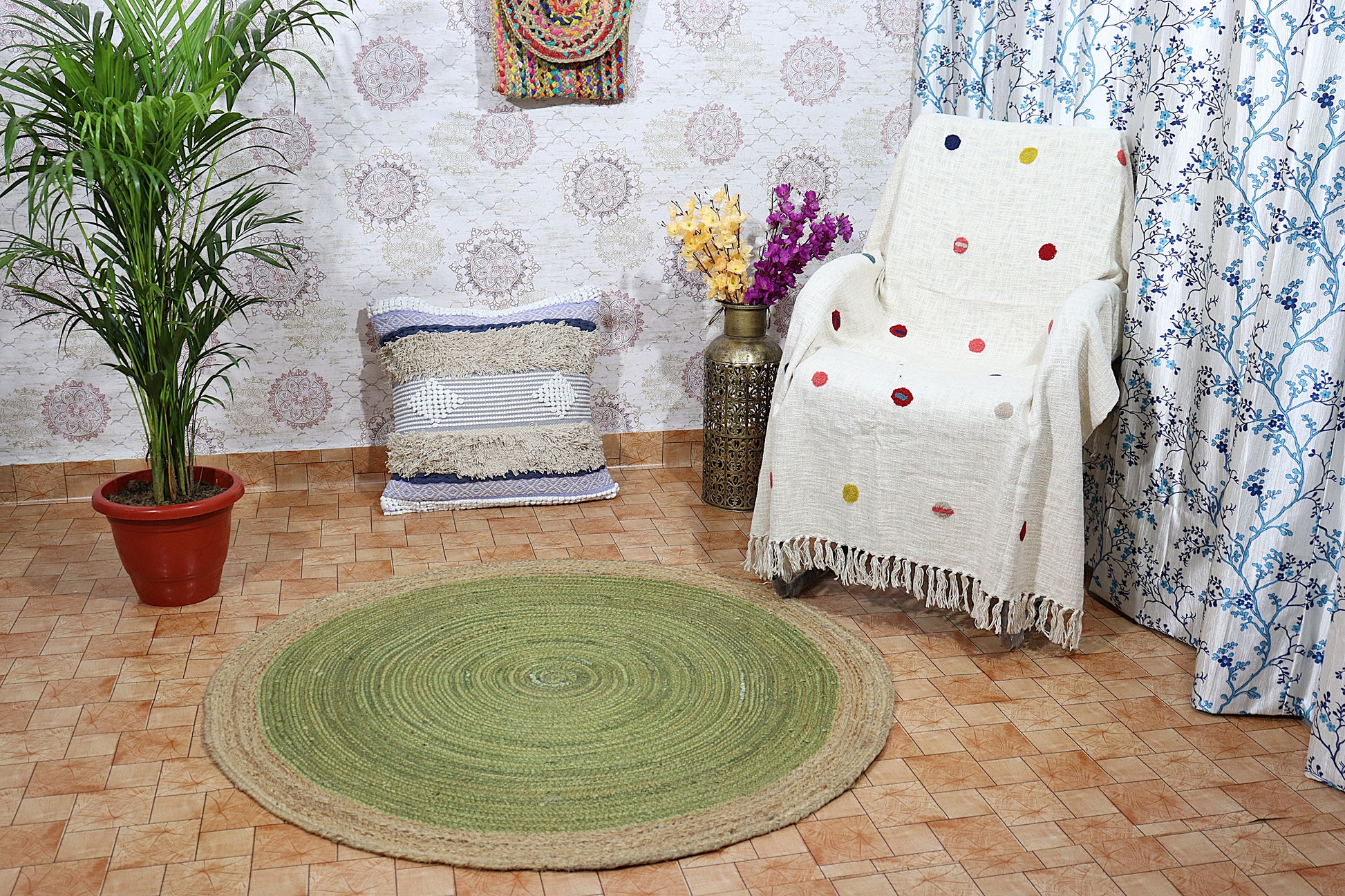 Room interior with a green circular rug, white chair with colorful polka dot blanket, and decorative elements.