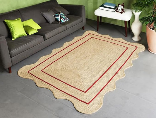 Beige rug with red border in a living room setting