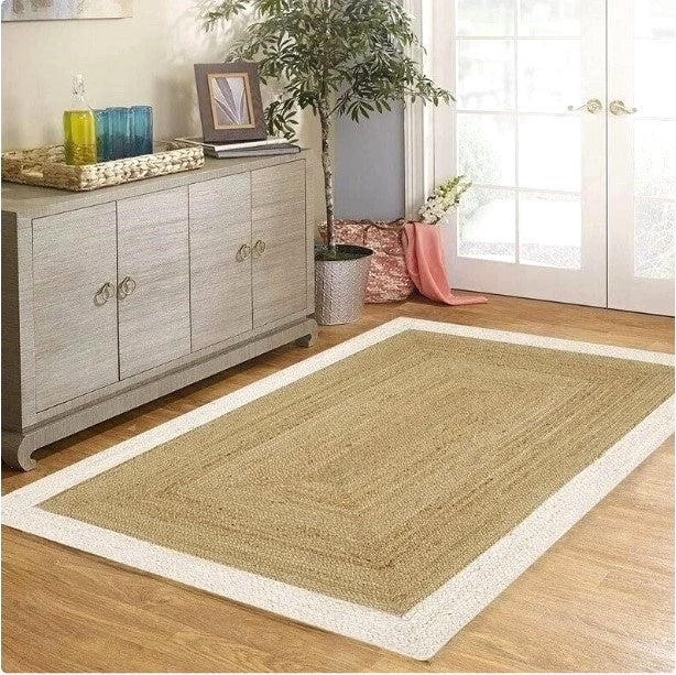 Beige rug with white border on wooden floor in room with furniture and decor