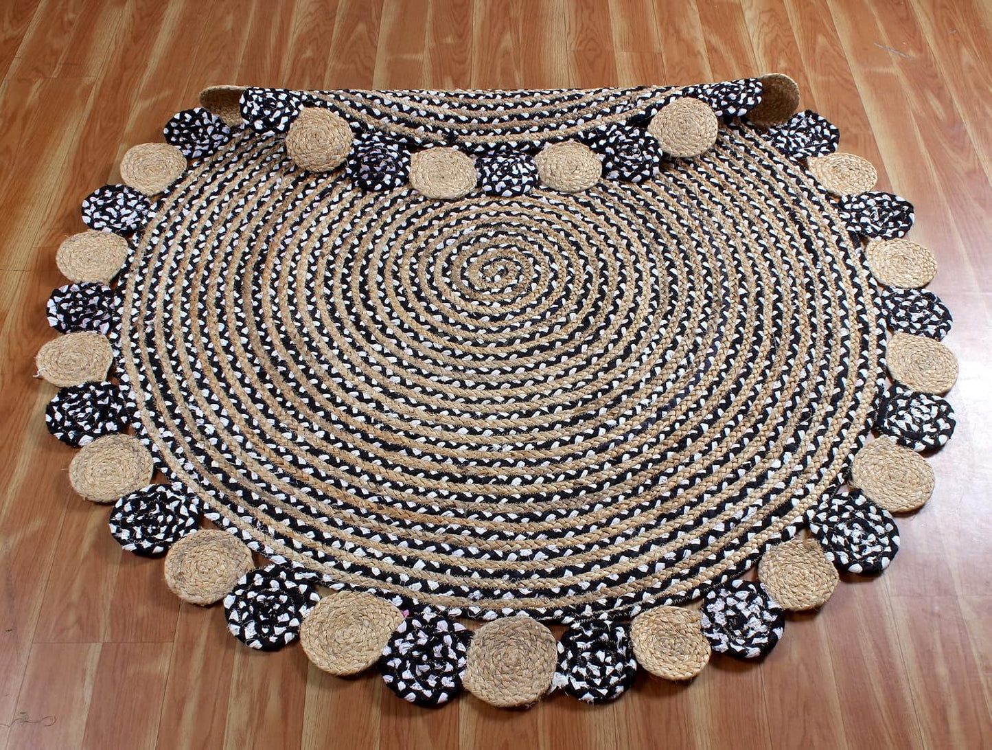 Round braided rug with decorative border on a wooden floor